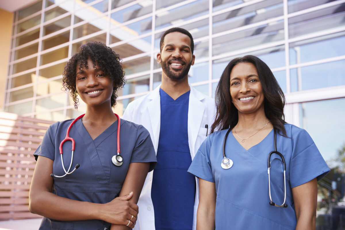 three-healthcare-colleagues-standing-outside